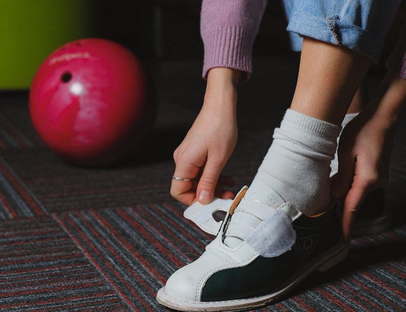 Close up of sports shoes on a dark wooden floor.