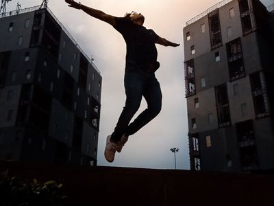 Silhouette of a person jumping in a dark room.